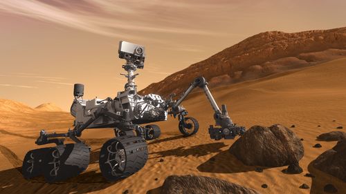 Le robot Curiosity sillonnera la terre martienne à la recherche de traces de vies fossiles. Vue d’artiste